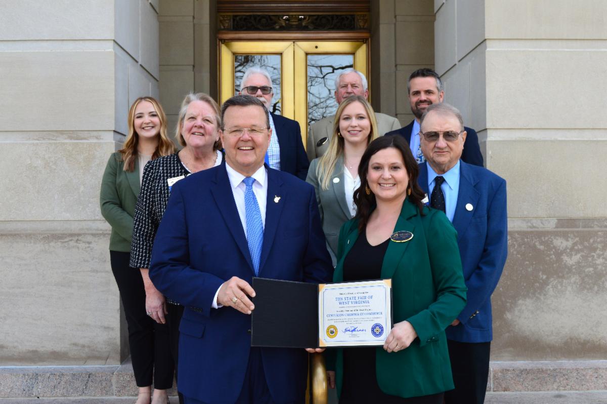 Secretary of State Kris Warner presenting the WV Centurion Chamber of Commerce certificate to WV State Fair CEO Kelly Tuckwiller Collins